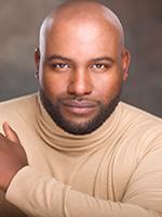 LaDarrion Williams headshot of him looking at the camera wearing a light beige long sleeve turtleneck with his left hand resting near his left shoulder