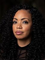 Tiffany Jackson headshot with her looking at the camera and wearing her hair down and a black collarless top